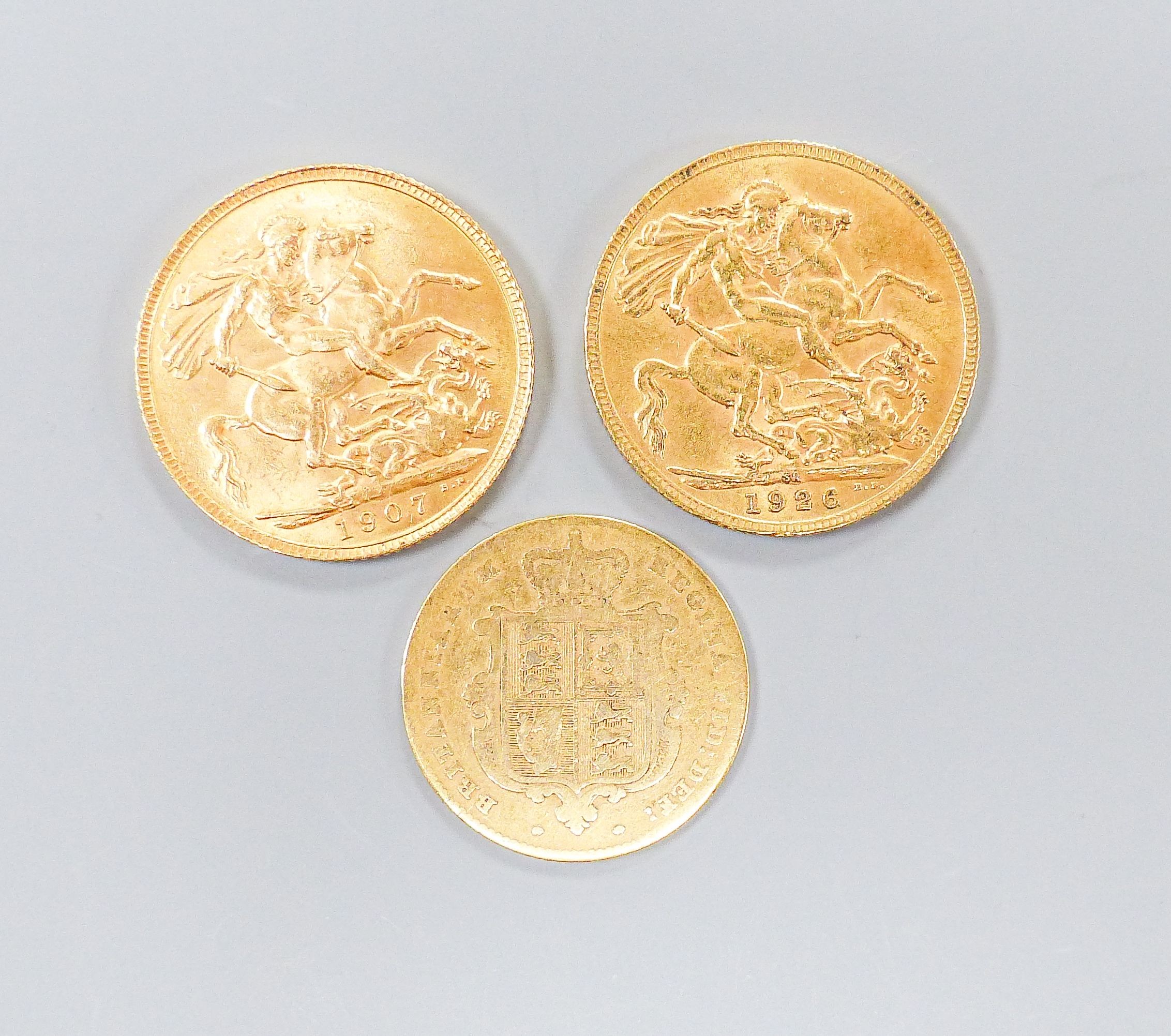 An Edward VII gold sovereign, 1907, a George V sovereign, 1926 and a Victoria half-sovereign, 1848 (worn)